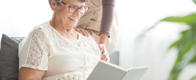 older woman reading a book smiling